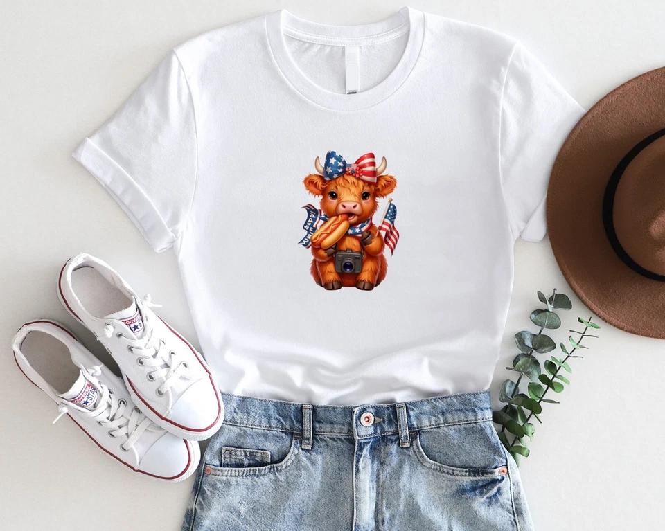 Patriotic Highland Cow T-Shirt – Cute 4th of July Cow with Hot Dog & Flag Patriotic Highland Cow T-Shirt – Cute 4th of July Cow with Hot Dog & Flag
